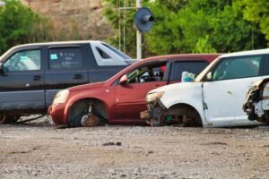 Auto a fine vita in un centro di raccolta, con ruote e parti anteriori già rimosse: è il momento in cui parte la pratica di demolizione e radiazione dal PRA