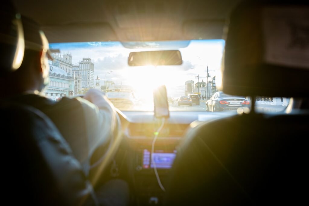 Person driving a car in the city — tracking work miles for tax deductions