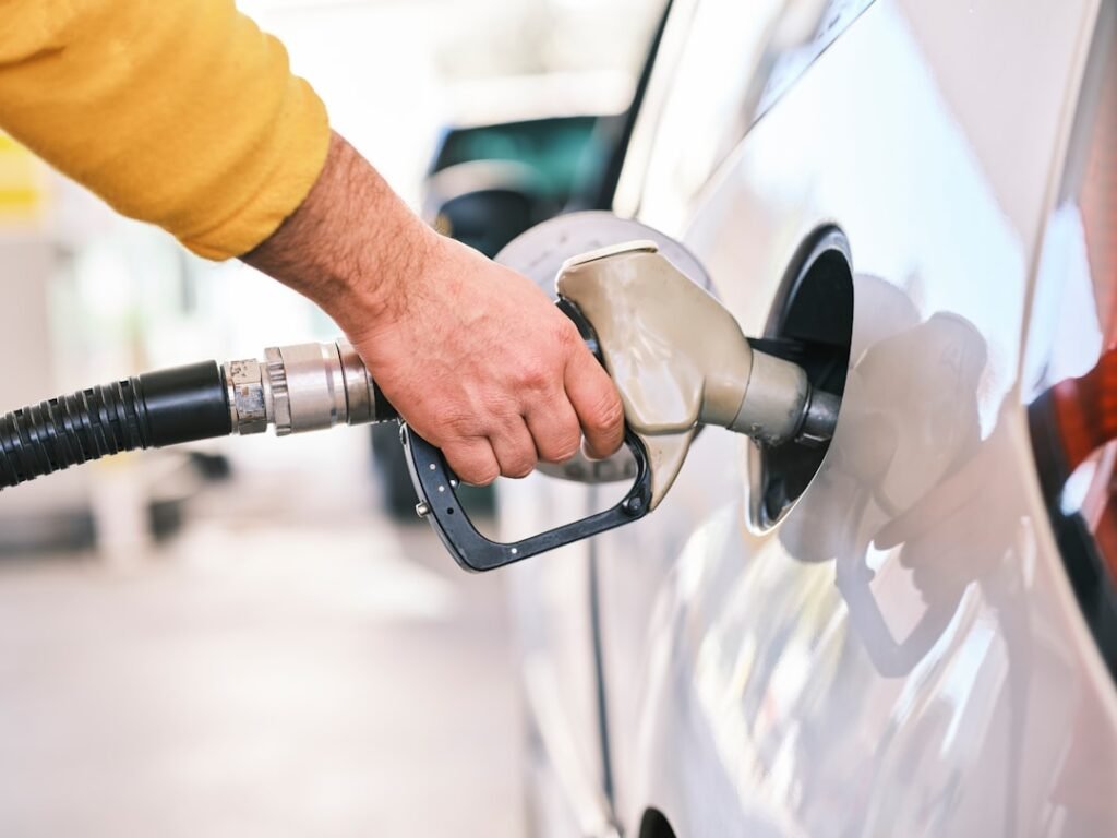 Filling up at a gas pump — the pump total and the trip odometer are the two numbers needed to calculate MPG