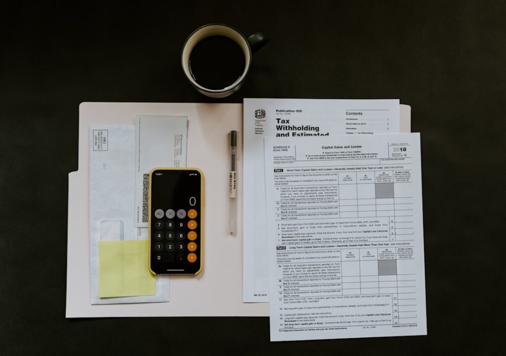 Self-employed worker calculating tax deductions with receipts and a calculator