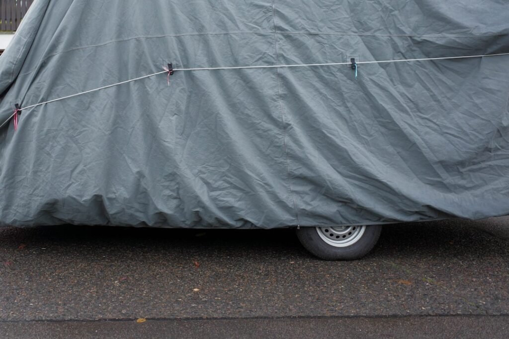 Auto coperta da un telo e legata, ferma a bordo strada: con il fermo amministrativo iscritto al PRA il veicolo resta di proprieta ma non puo circolare