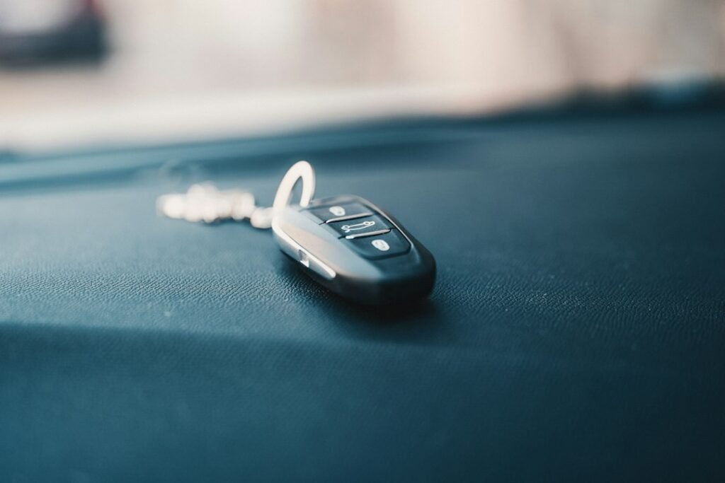 A car key fob on the dashboard of an employee's own car — a car allowance pays for the car you already own, and the tax follows how it is paid
