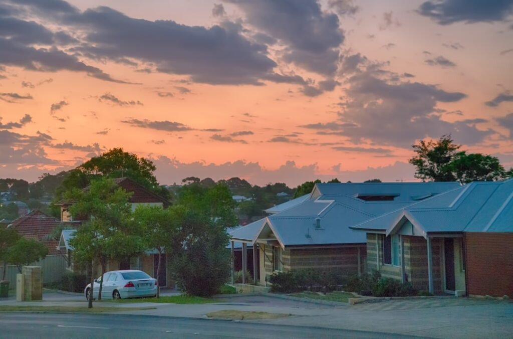 A car parked outside a suburban house in Perth at first light, before the drive that decides whether the day's kilometres are work-related